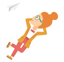 Image showing Business woman relaxing on cloud.