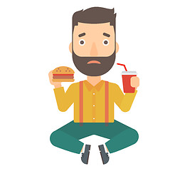 Image showing Man eating hamburger. 