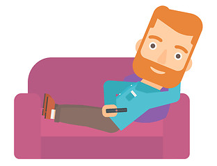 Image showing Man sitting on the couch with remote control.