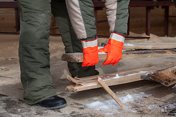 Image showing Carpenter working at sawmill 