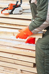 Image showing Carpenter working at sawmill 