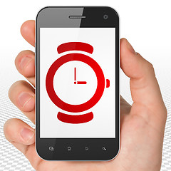 Image showing Timeline concept: Hand Holding Smartphone with Hand Watch on display