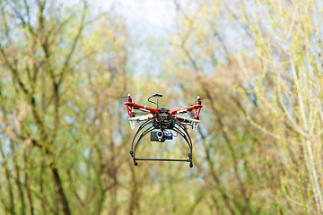 Image showing Quadrocopter while flying in the forest. 