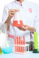 Image showing hands holding test tubes with chemical elements. 