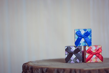 Image showing Gift box with blue bow on wood background