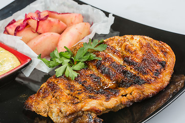 Image showing plate of grilled meat with fries