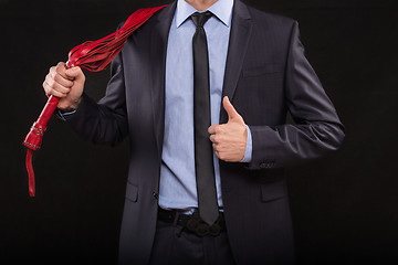 Image showing man in business suit with chained hands. handcuffs for sex games