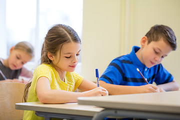 Image showing group of school kids writing test in classroom