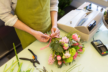 Image showing close up of florist man with bunch at flower shop