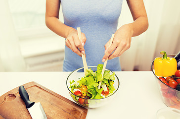 Image showing close up of woman cooking vegetable salad at home