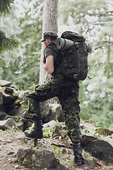 Image showing young soldier with backpack in forest