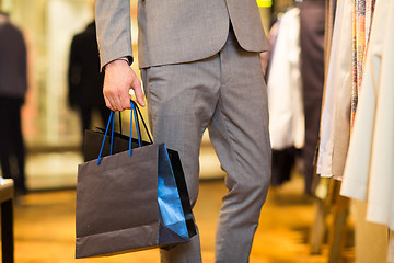 Image showing close up of man with shopping bags at  store