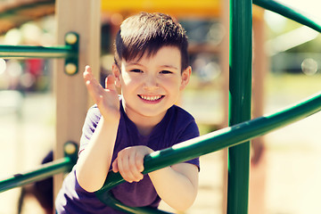 Image showing happy little boy climbing on children playground