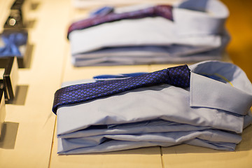 Image showing close up of shirts with ties at clothing store