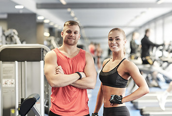 Image showing smiling man and woman in gym