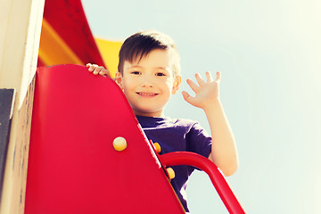 Image showing happy little boy climbing on children playground
