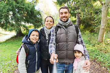 Image showing family with backpacks taking selfie and hiking