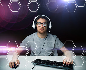 Image showing man in headset computer over hexagons projection