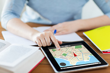 Image showing close up of woman with navigator map on tablet pc