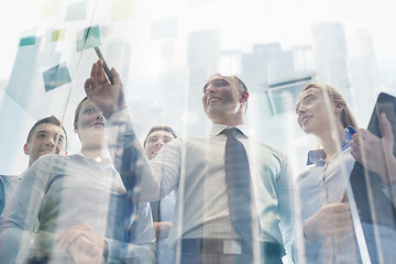 Image showing smiling business people with marker and stickers