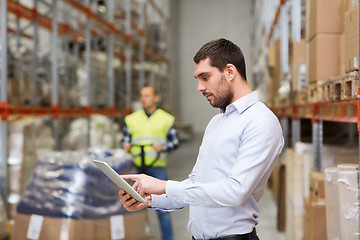 Image showing businessman with tablet pc at warehouse