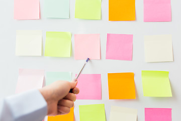 Image showing close up of hand pointing to sticker on flip chart