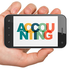 Image showing Banking concept: Hand Holding Smartphone with Accounting on  display