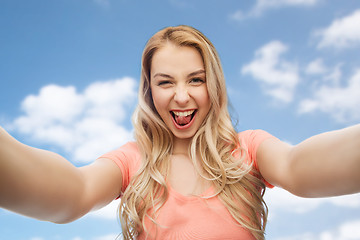 Image showing happy smiling young woman taking selfie