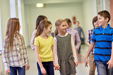 Image showing group of smiling school kids walking in corridor