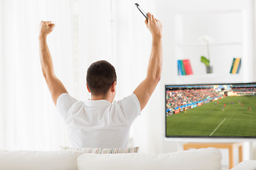 Image showing happy man watching football or soccer game on tv