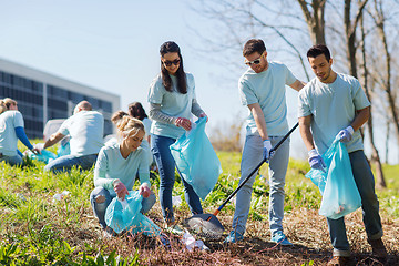 Image showing volunteers with garbage bags cleaning park area