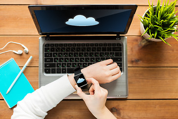 Image showing close up of woman with smart watch and laptop