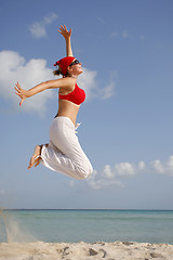 Image showing Woman jumping on the Beach