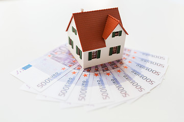 Image showing close up of home or house model and money