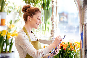 Image showing florist woman with clipboard at flower shop