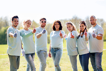 Image showing group of volunteers showing thumbs up in park