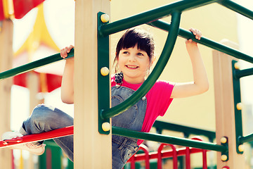 Image showing happy little girl climbing on children playground