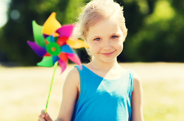 Image showing happy little girl with colorful pinwheel at summer