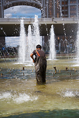 Image showing Men clean of fountain pool.