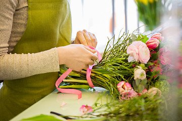 Image showing close up of woman making bunch at flower shop