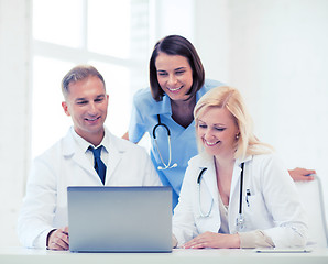 Image showing group of doctors looking at tablet pc