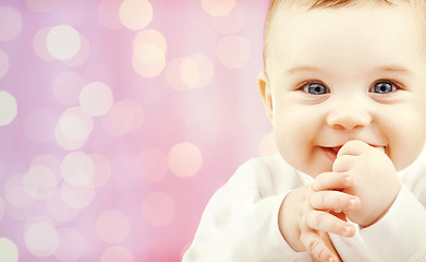 Image showing happy baby over pink lights background