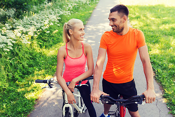 Image showing happy couple riding bicycle outdoors