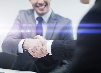 Image showing two businessmen shaking hands in office