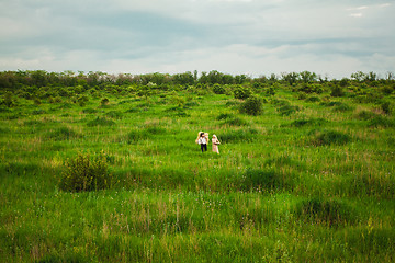 Image showing The healthy rural life. The woman and man in the green field