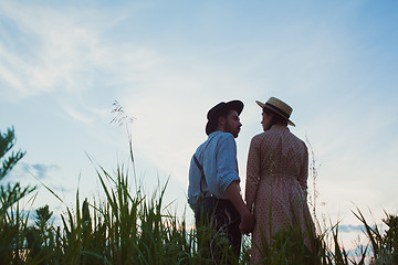 Image showing Young couple in love in the meadow