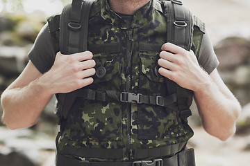 Image showing close up of young soldier with backpack in forest