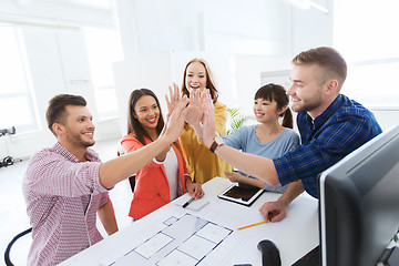 Image showing creative team making high five at office