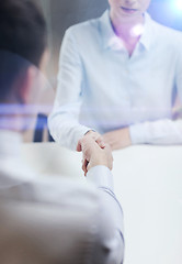 Image showing businesswoman and businessman shaking hands