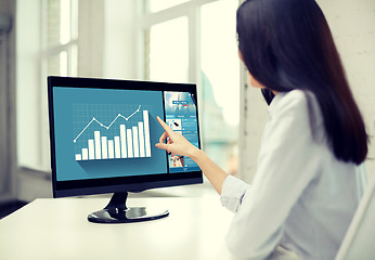 Image showing close up of woman with chart on computer in office